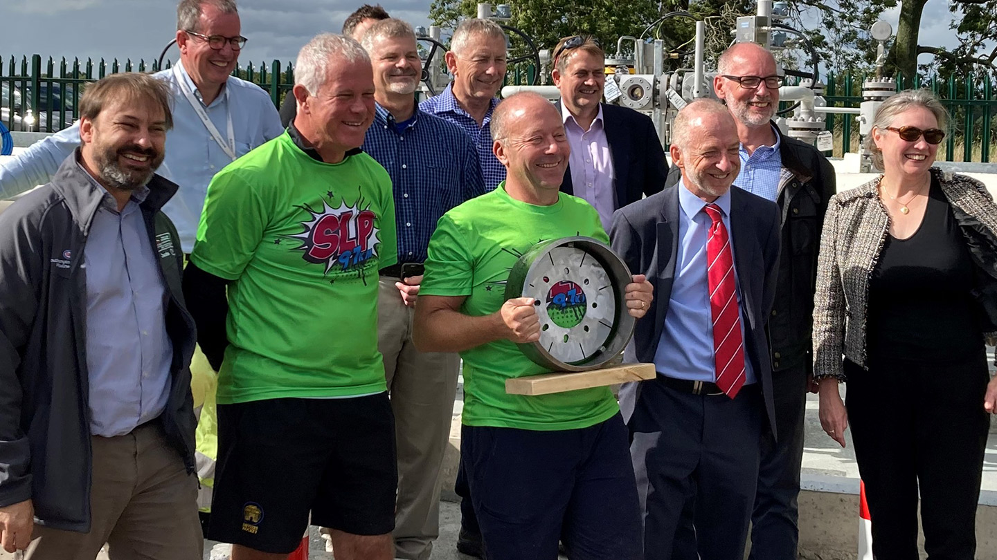 Representatives from ExxonMobil, Jacobs, Fisher German and SCTW gather at Boorley Green in Hampshire, which was the location of the final connection of the Southampton to London Pipeline  the trophy ring is the exact diameter of the new pipeline.