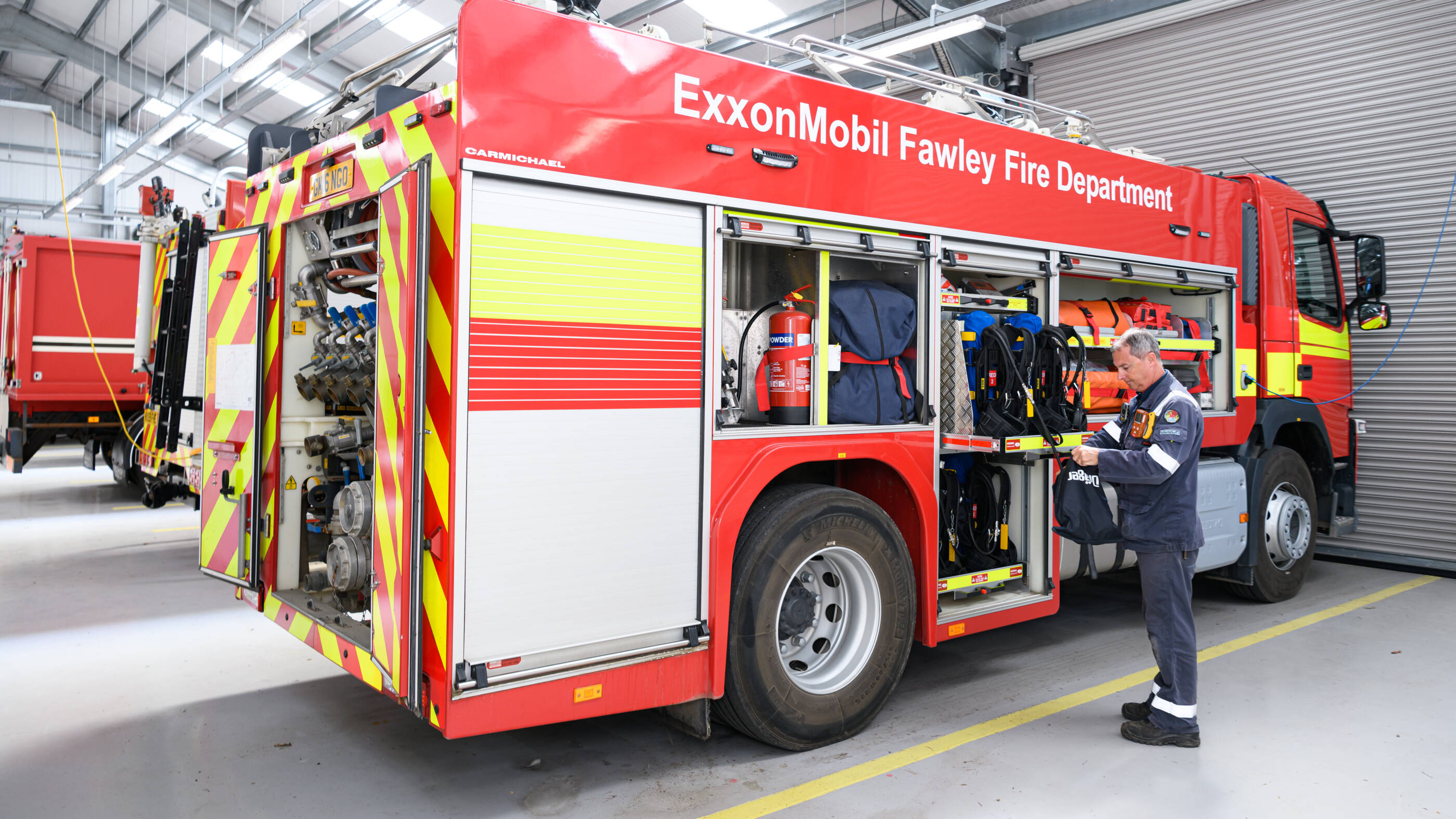 A member of the Fire Response Group (FRG) alongside one of the fire engines at Fawley.